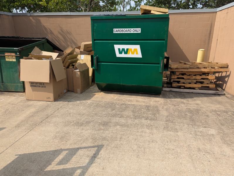 Dumpster area before PhD Junk Removal cleared it